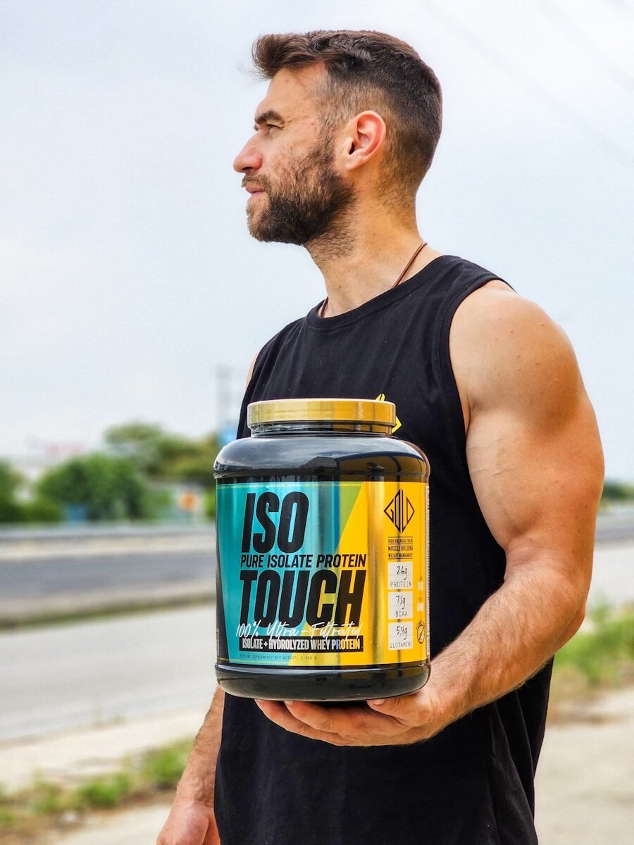 A man is holding a jar of protein